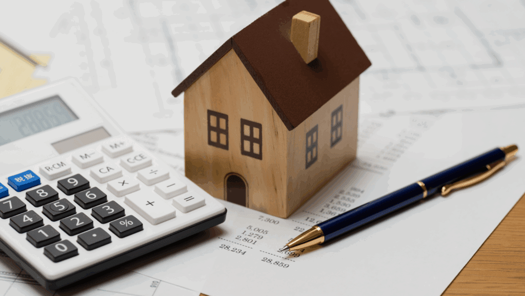 Calculator and house to signify tax