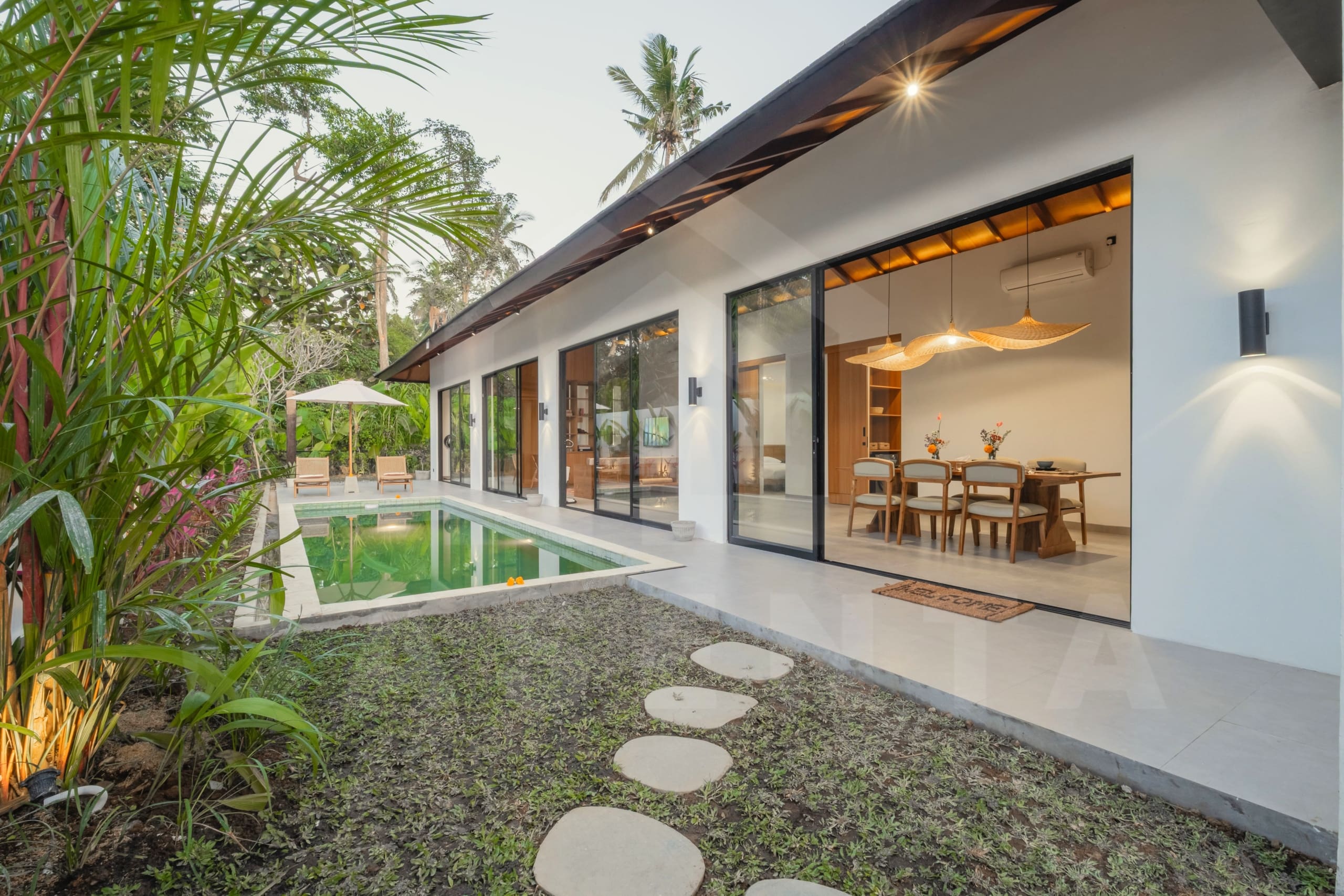 Private pool and lush outdoor lounging space at Ubud villa