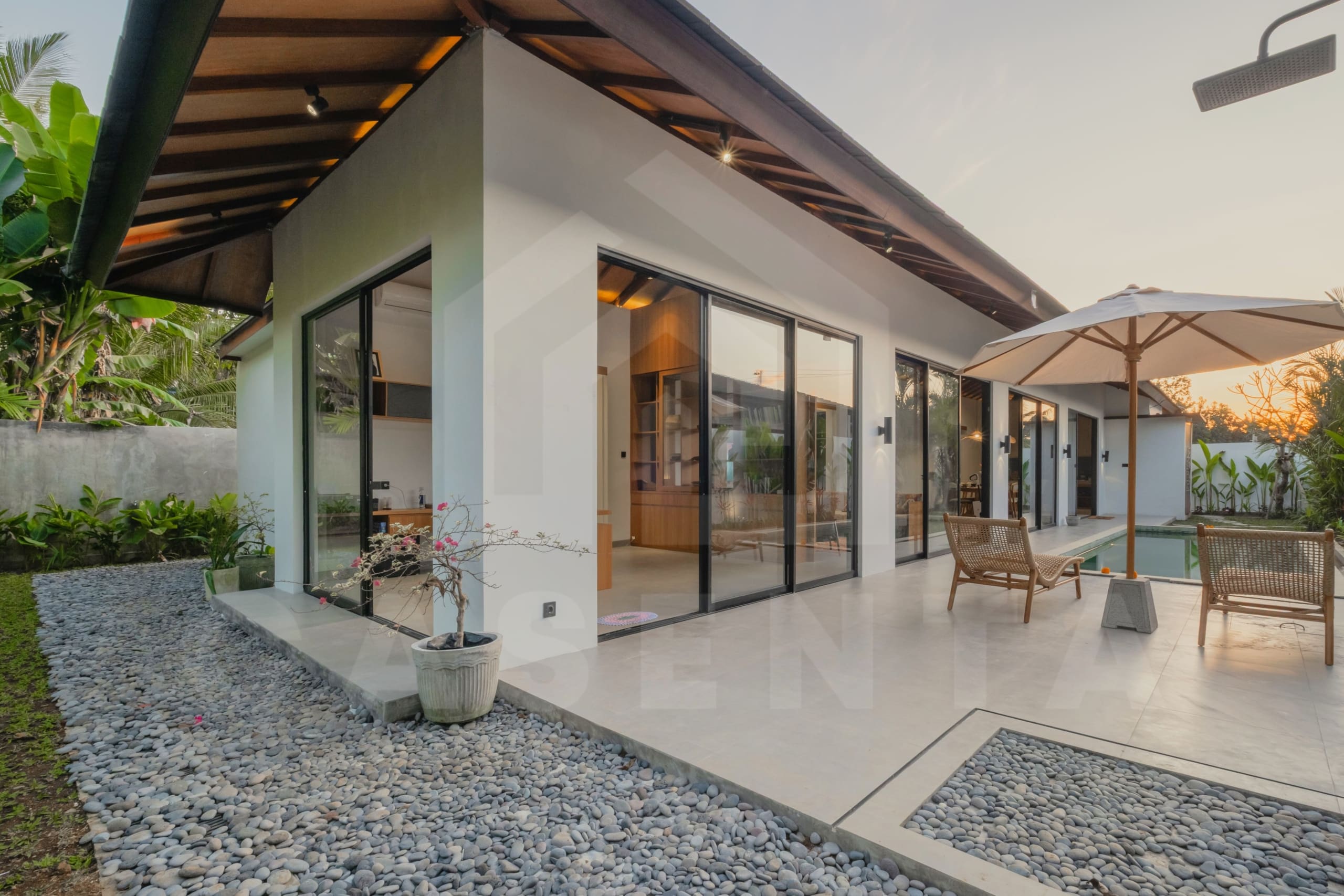 Modern Ubud leasehold villa exterior with pool and outdoor seating at dusk