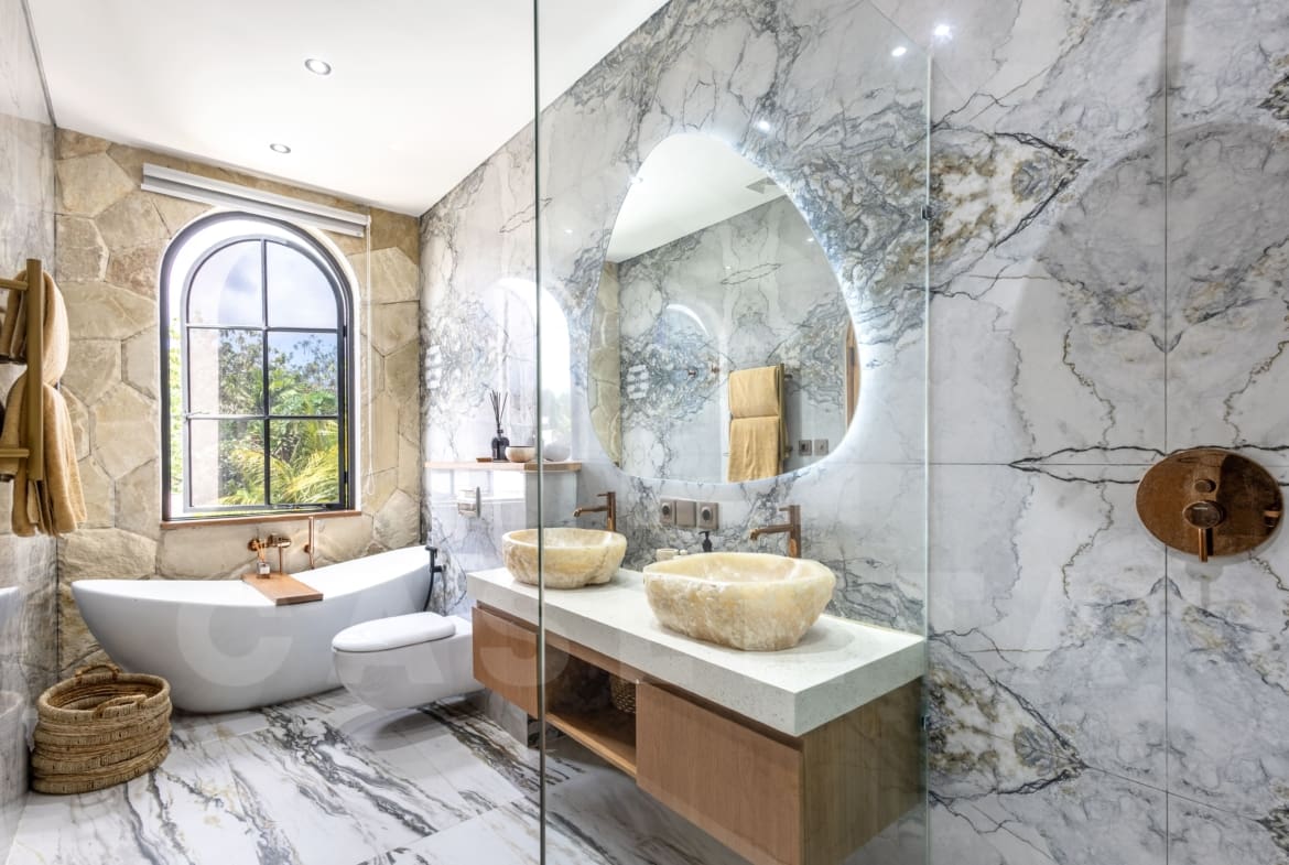 Bright marble bathroom with bathtub in Balangan villa