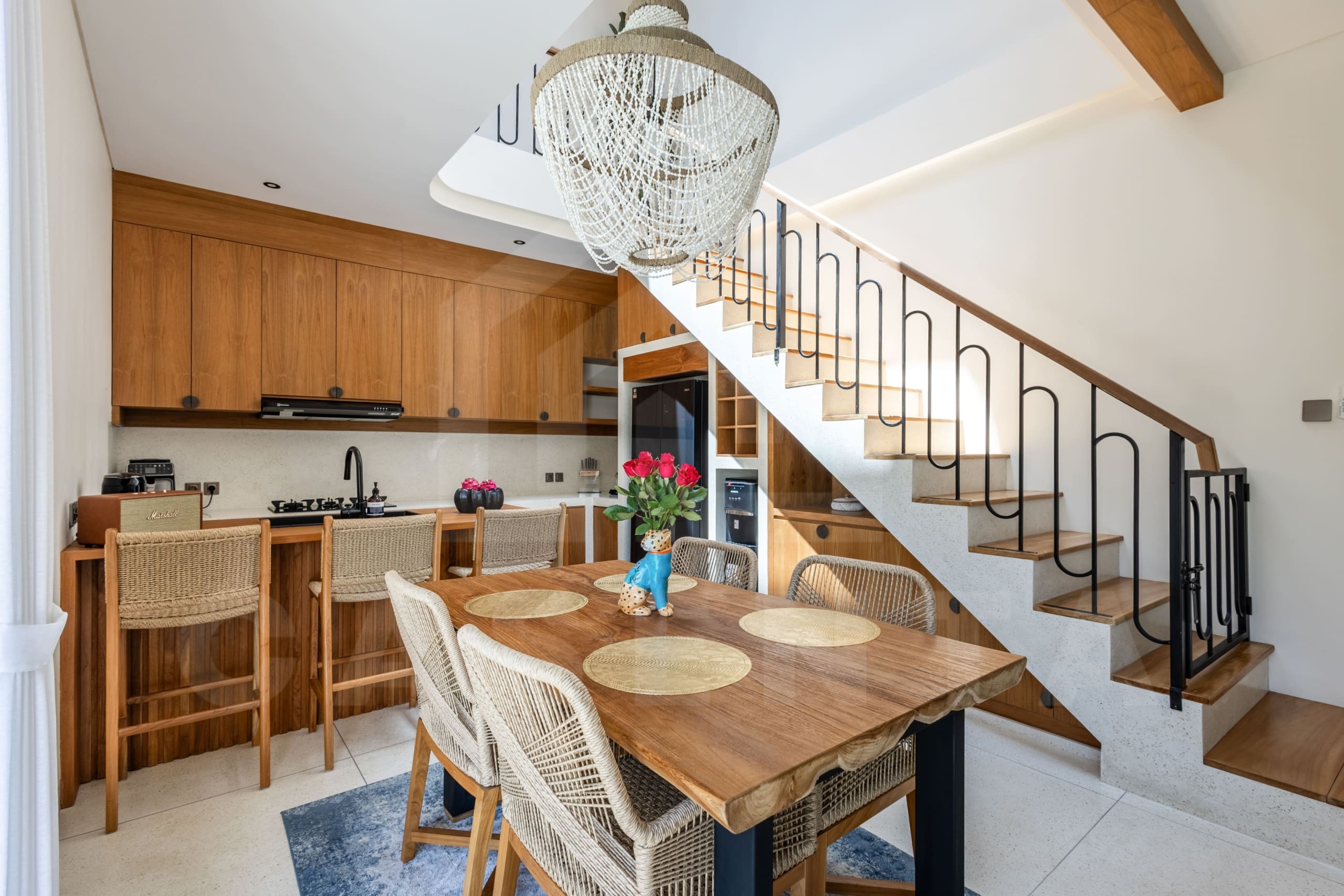 Elegant Balangan villa kitchen and dining area with wood accents