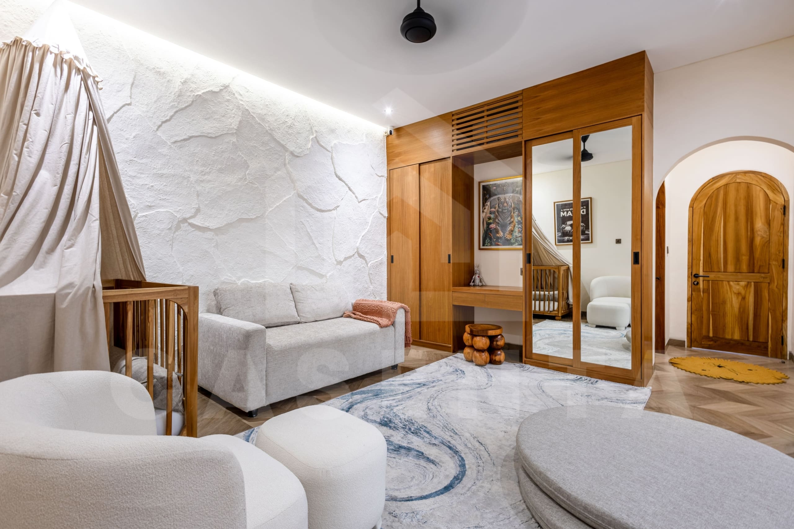 Modern Balangan villa bedroom with natural wood accents and cozy seating area