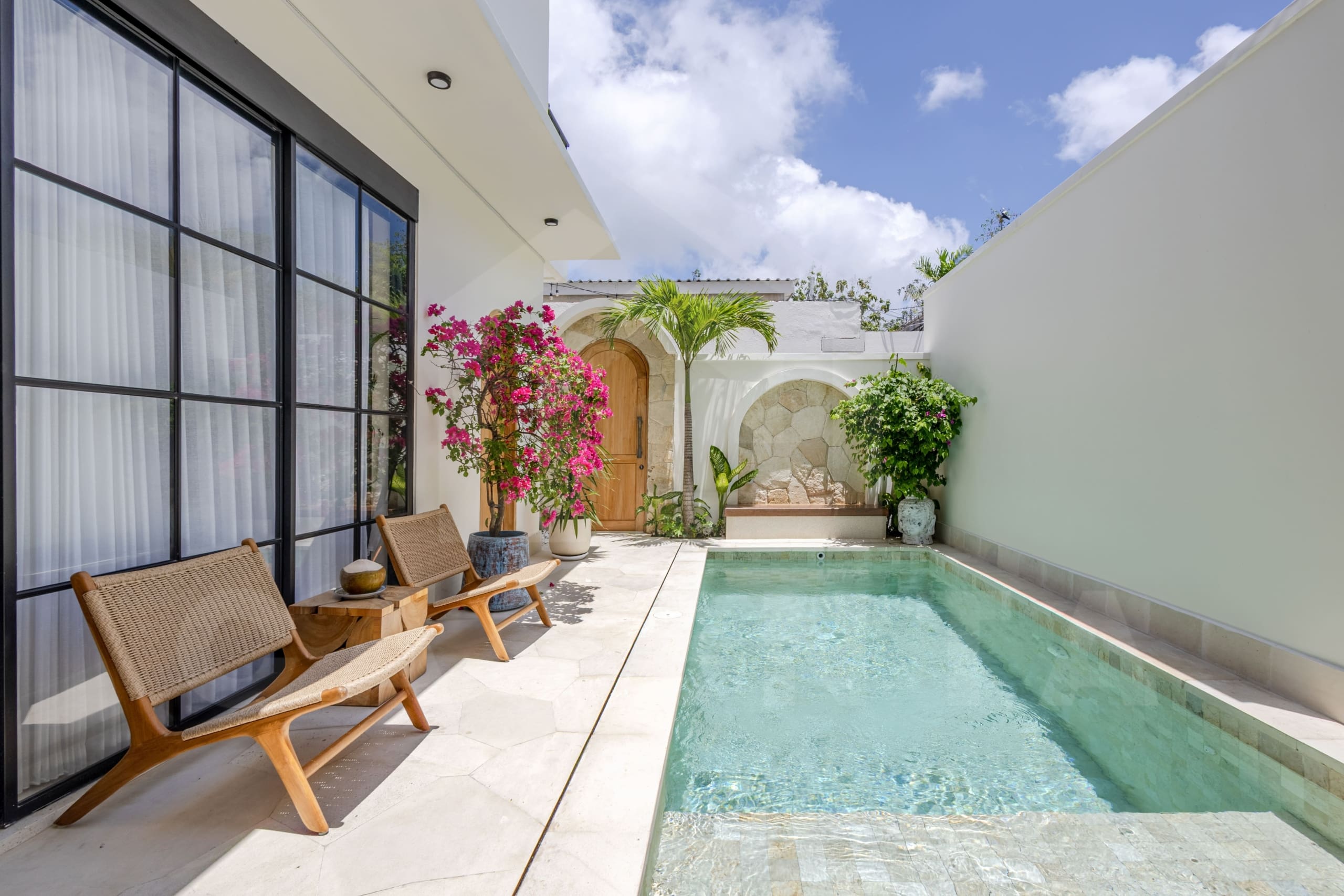 Private Balangan villa pool with tropical plants and bright sky backdrop