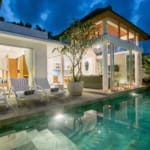 leasehold villa Berawa swimming pool at night with loungers and tropical landscaping