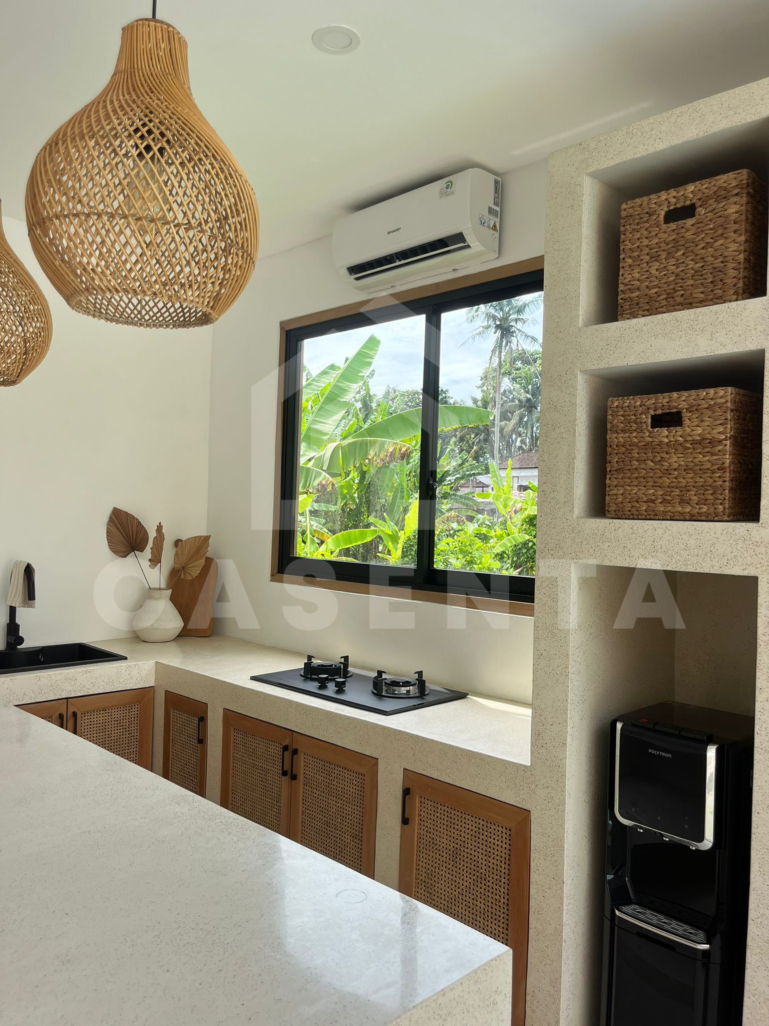 Modern tropical villa kitchen with stone countertops and garden view
