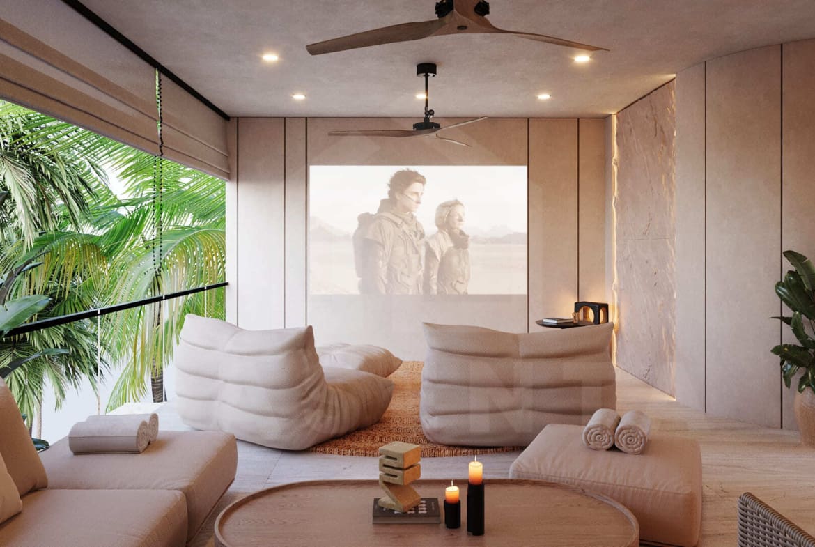 Cozy rooftop cinema lounge with plush seating, soft lighting, and tropical palm views.