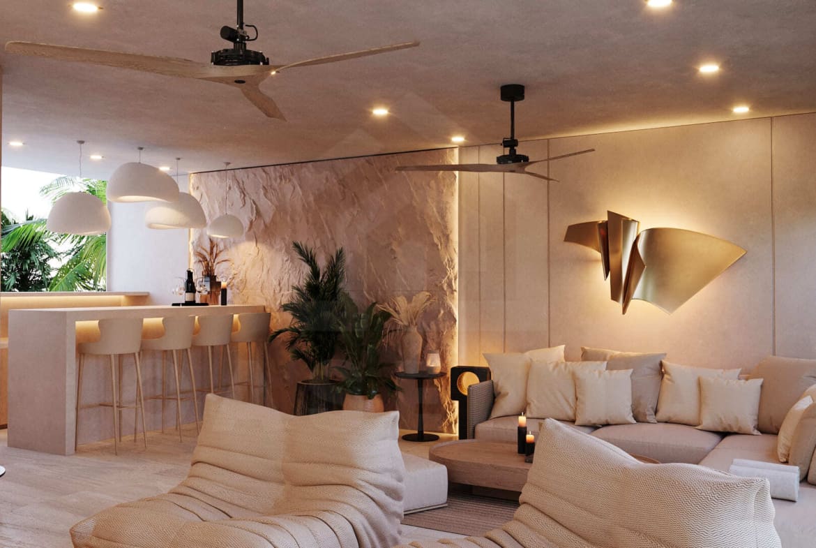 Modern tropical rooftop lounge with plush seating, warm lighting, and built-in bar overlooking lush greenery.