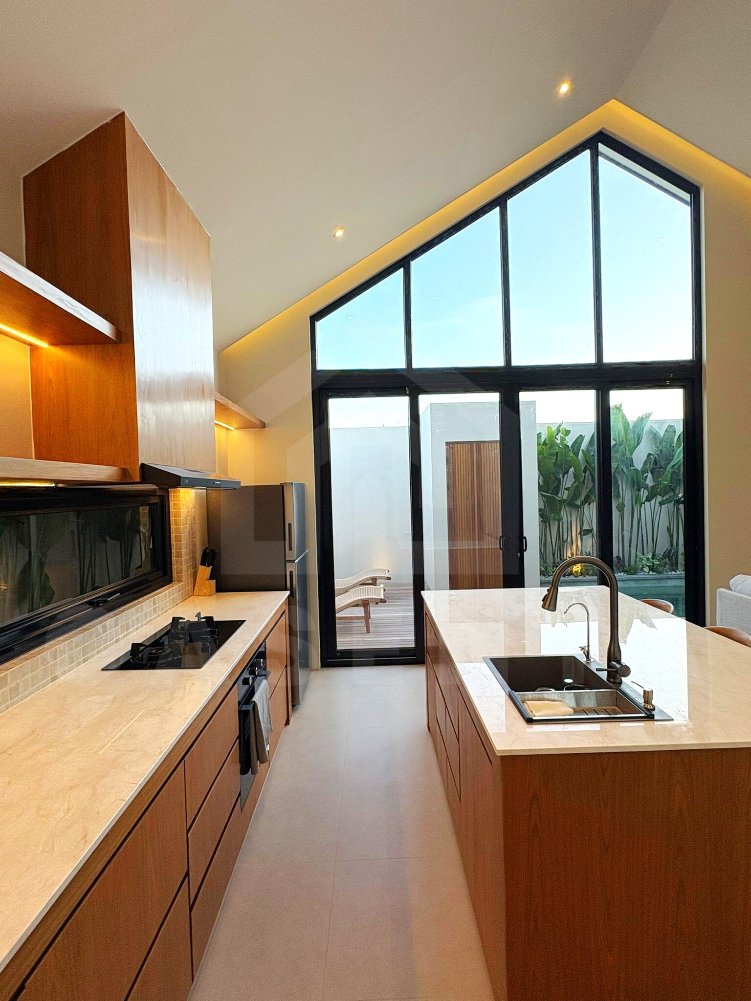 Fully equipped kitchen and dining island in Tumbak Bayuh villa