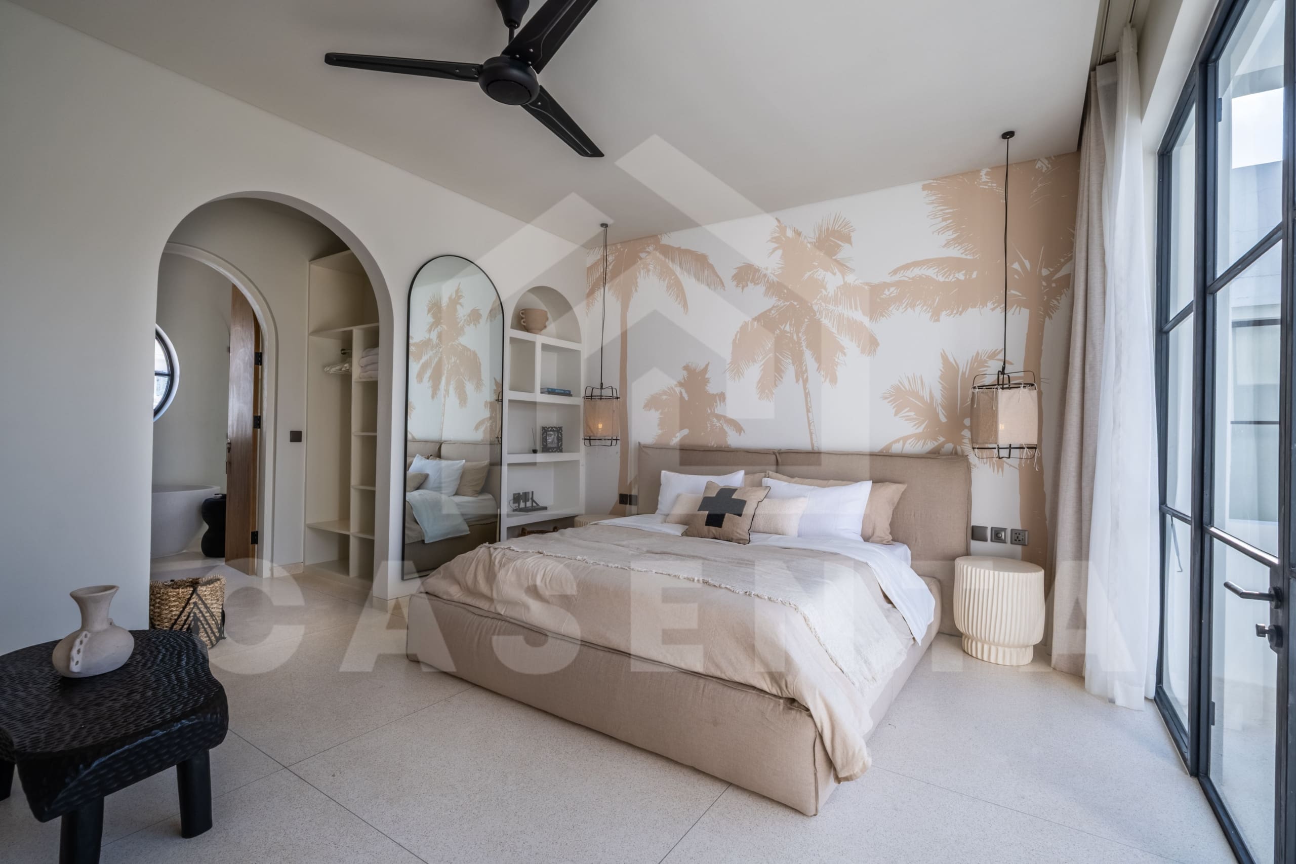 Tropical-inspired bedroom with palm print feature wall and arched architectural details