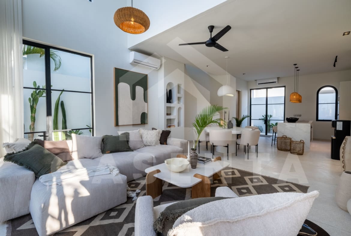 Open-plan living and dining area with modern furniture and neutral palette