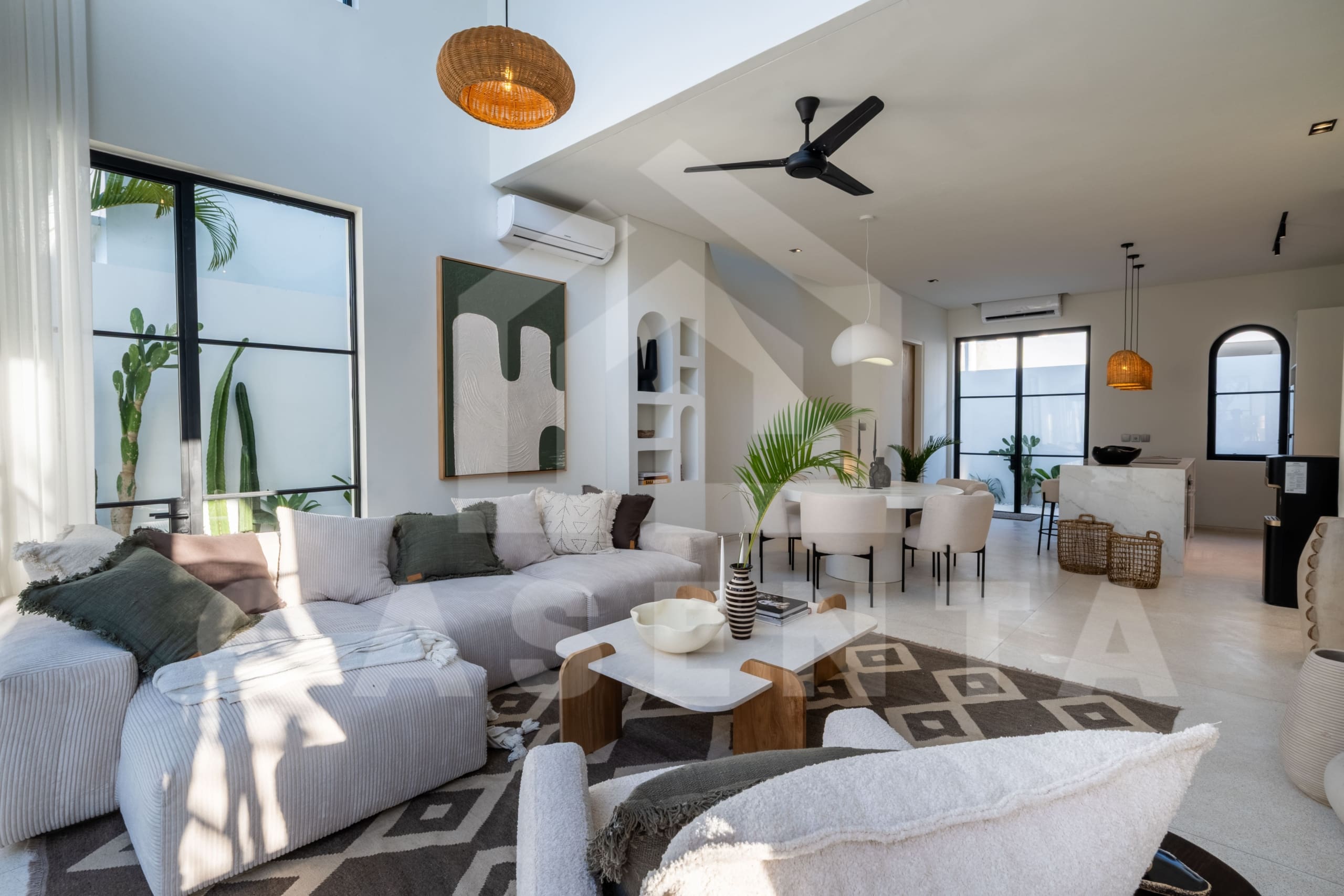 Open-plan living and dining area with modern furniture and neutral palette