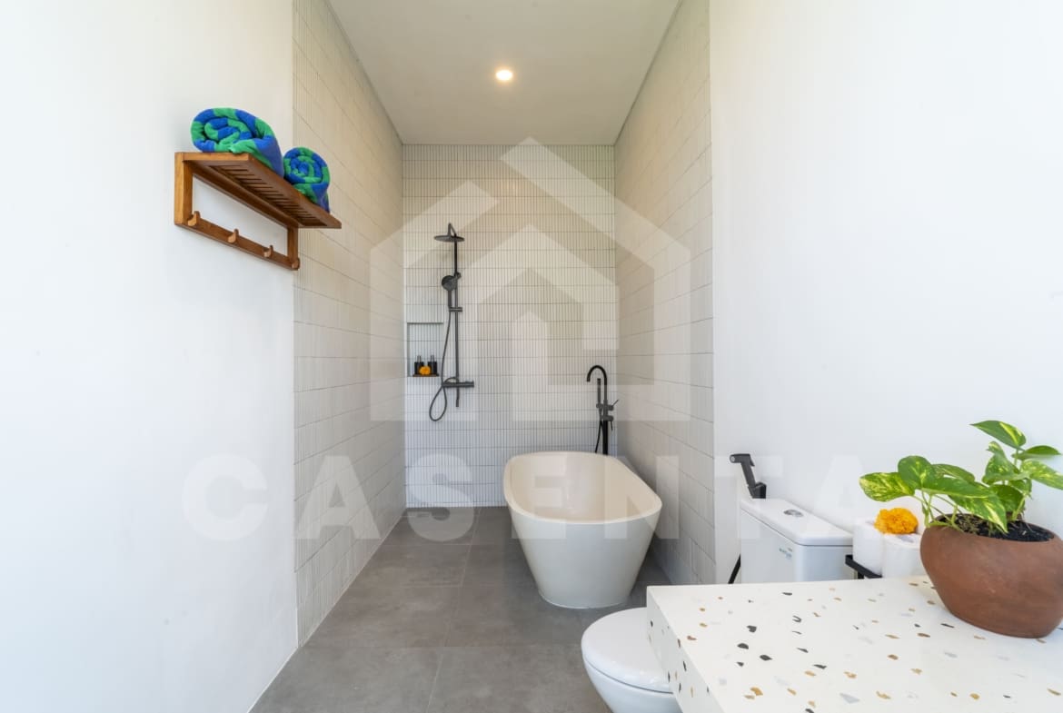Bathroom with freestanding bathtub in modern Canggu villa