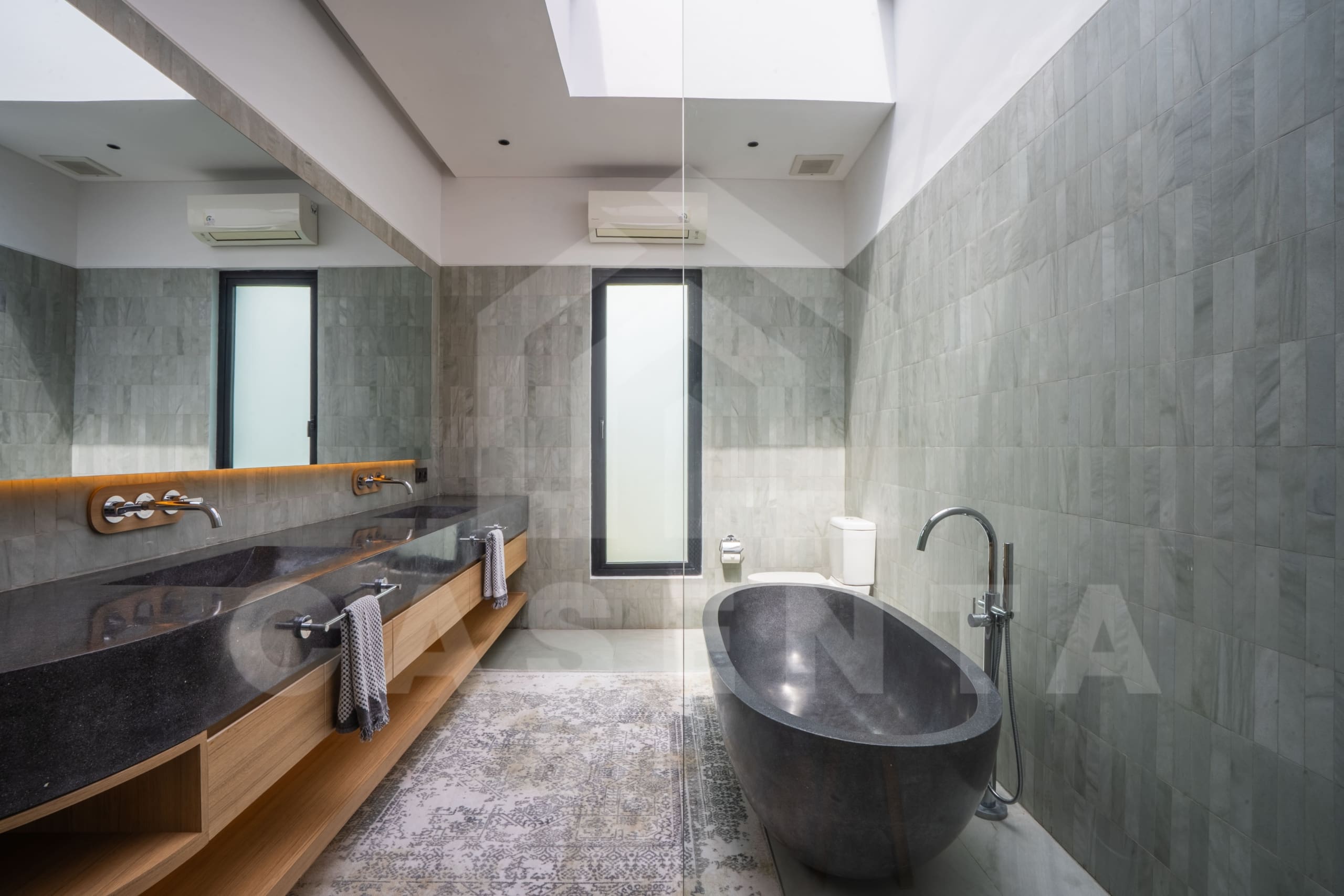 Luxury Villa Tumbak Bayuh bathroom with stone bathtub and double vanity