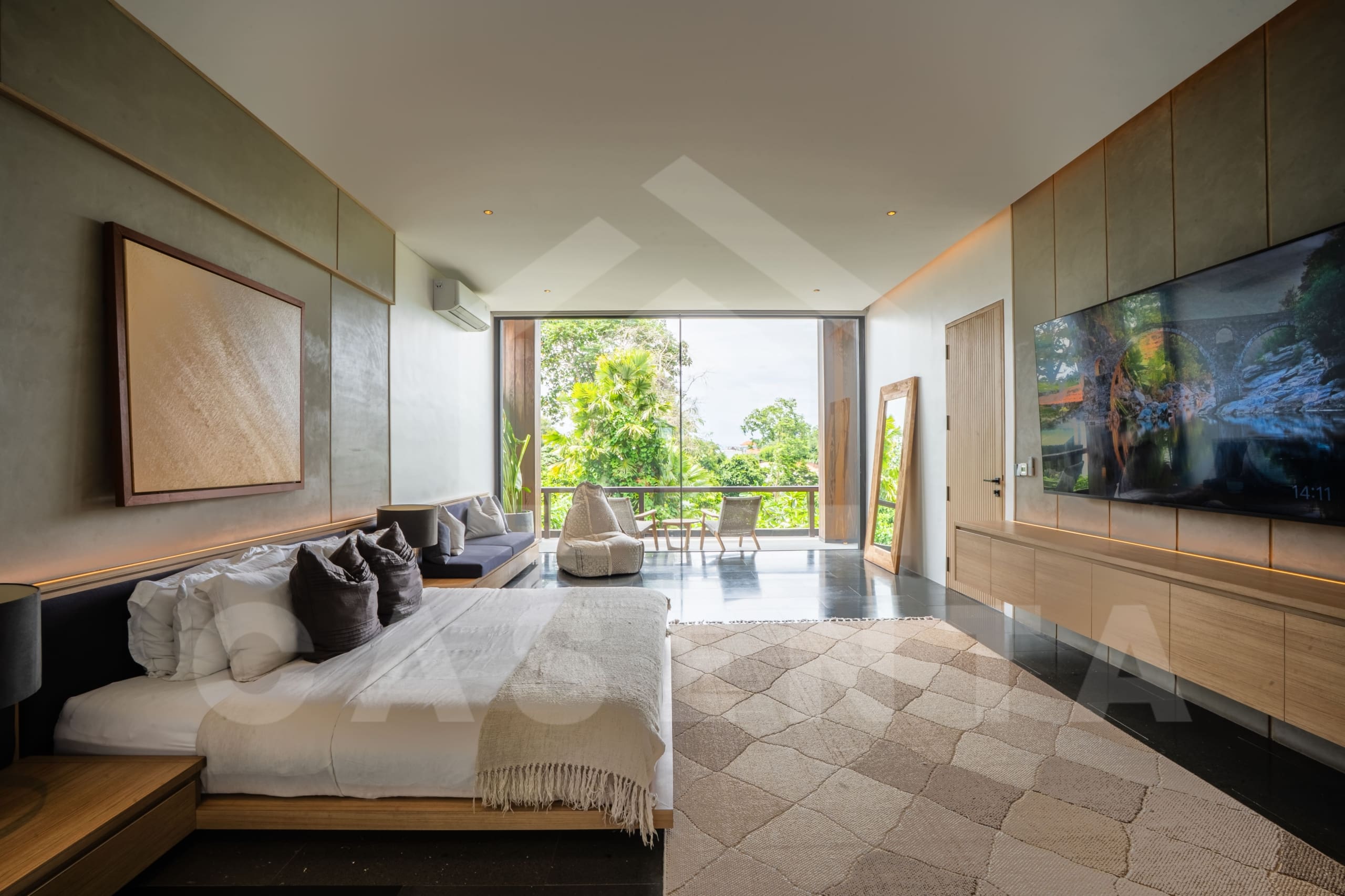Spacious bedroom interior in Luxury Villa Tumbak Bayuh with lounge seating
