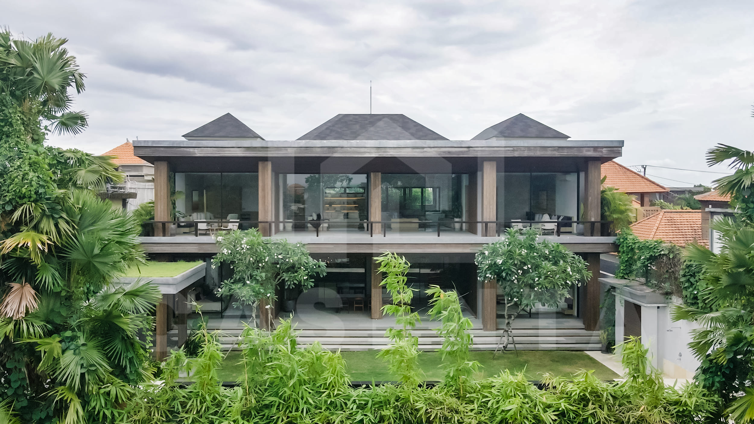 Modern two-storey Canggu villa with tropical landscaping and private balconies