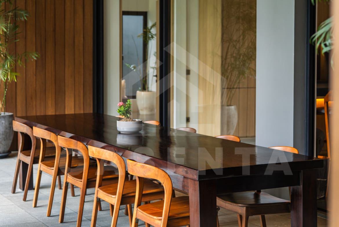 Outdoor dining area with wooden table at Canggu villa