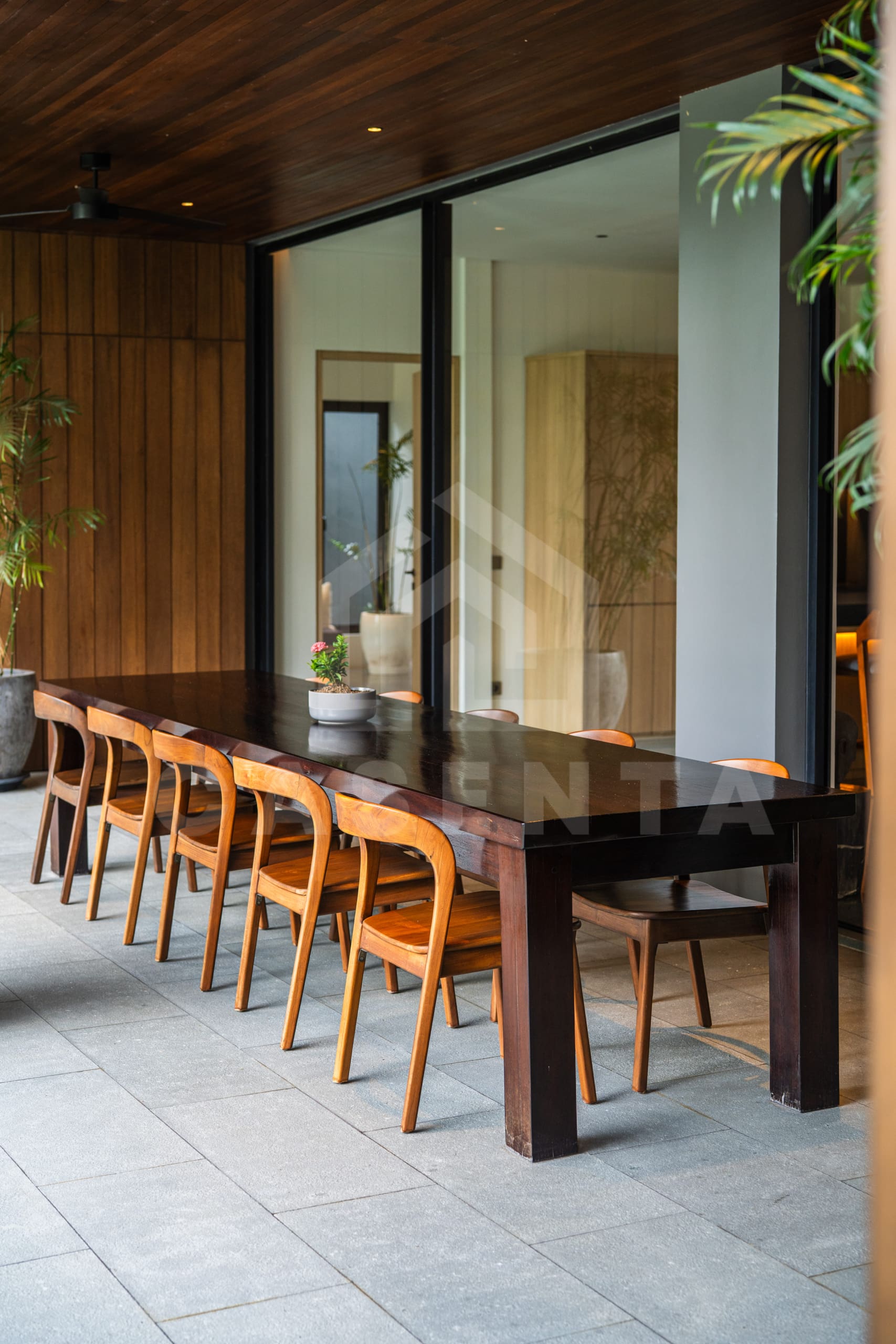 Outdoor dining area with wooden table at Canggu villa