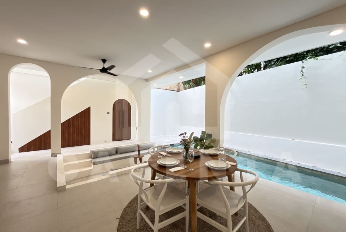 Open living and dining layout with pool view in Canggu villa