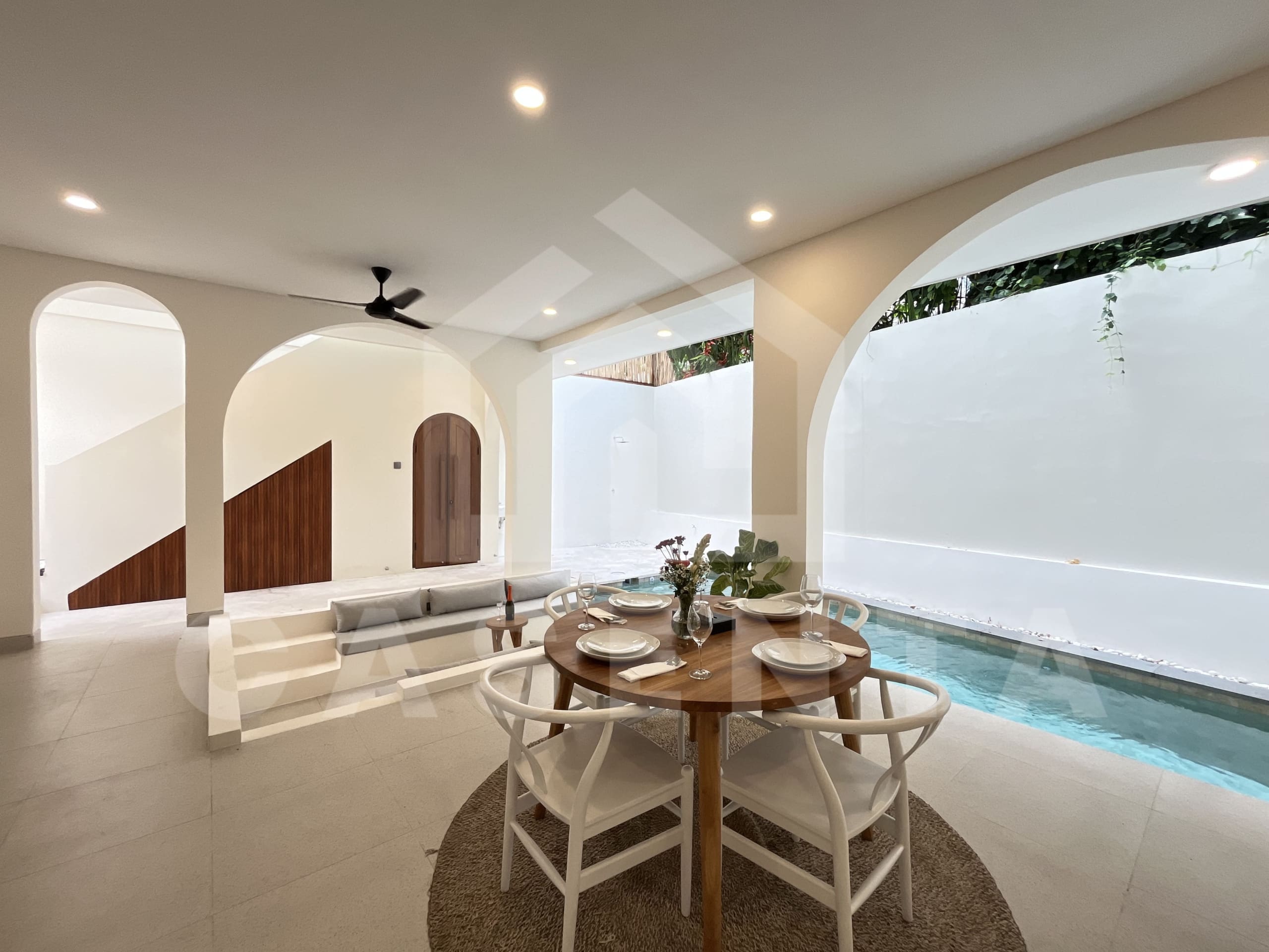 Open living and dining layout with pool view in Canggu villa