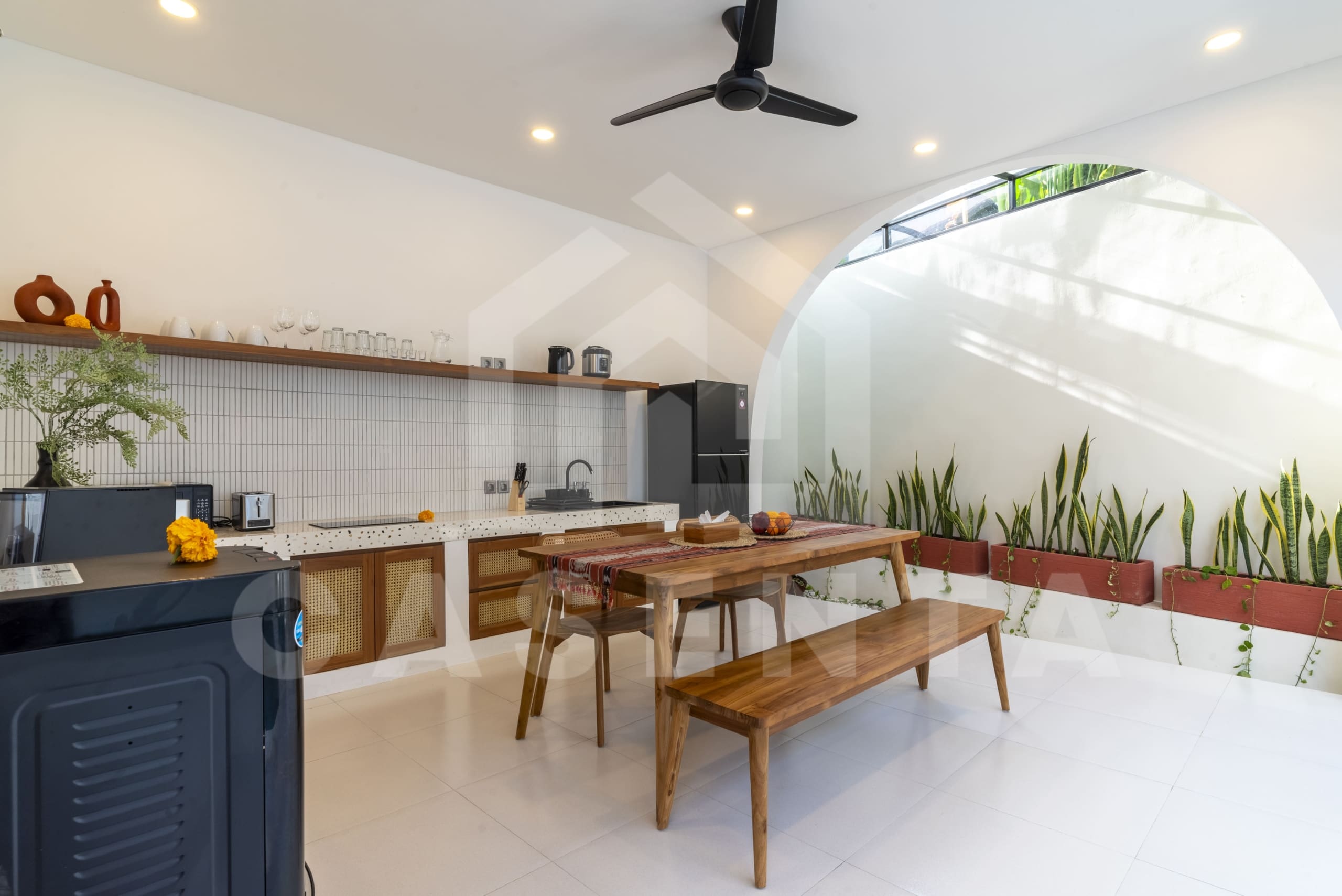 Modern kitchen and dining area in Canggu villa with terrazzo counters