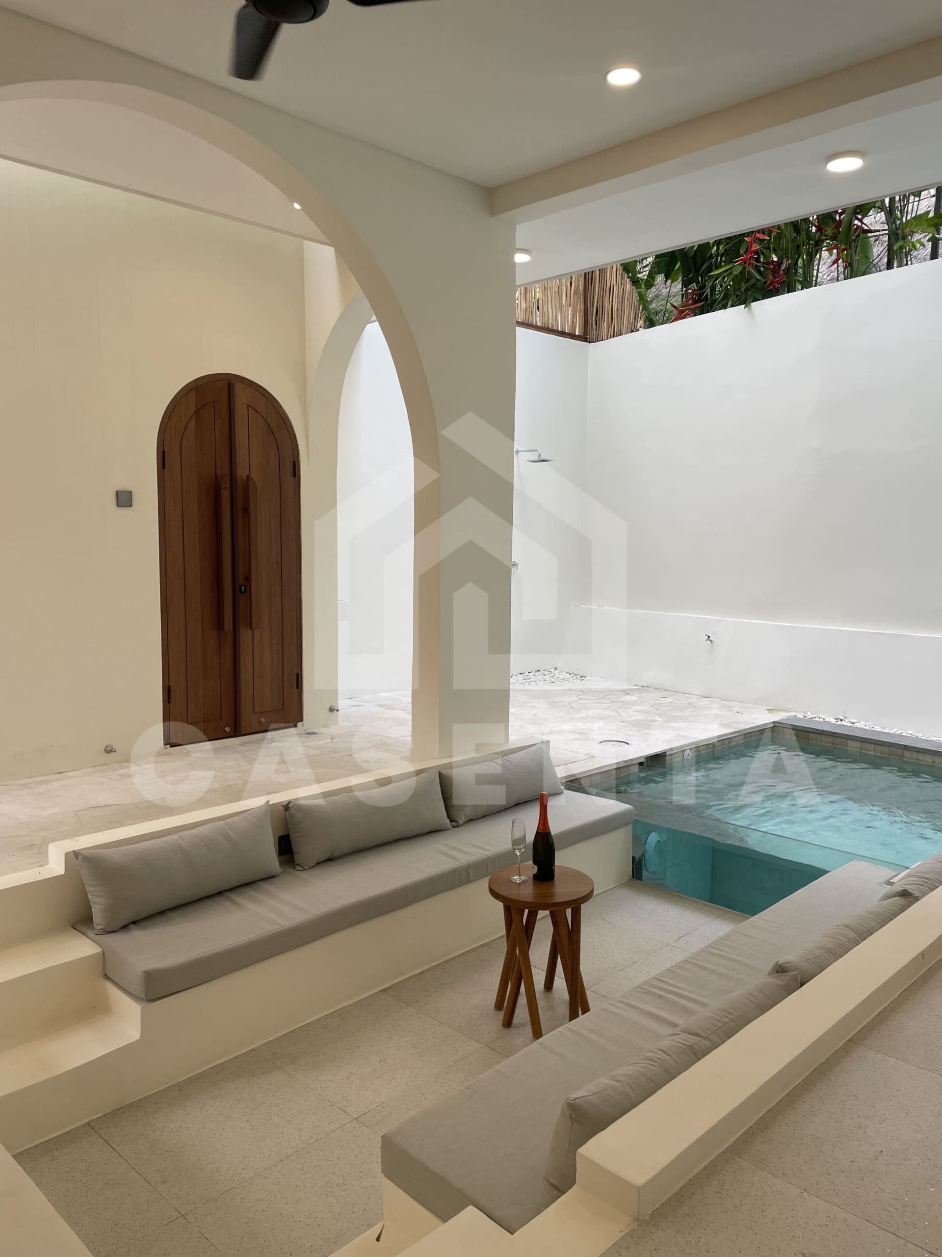 Sunken poolside seating in modern Canggu villa