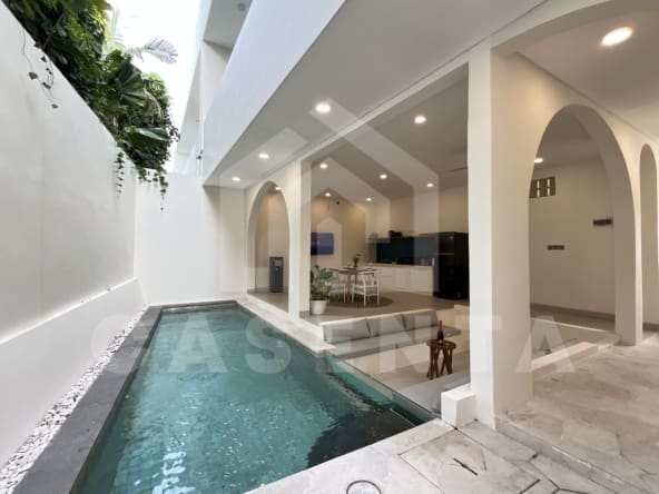 Private swimming pool beside living area in Padonan villa