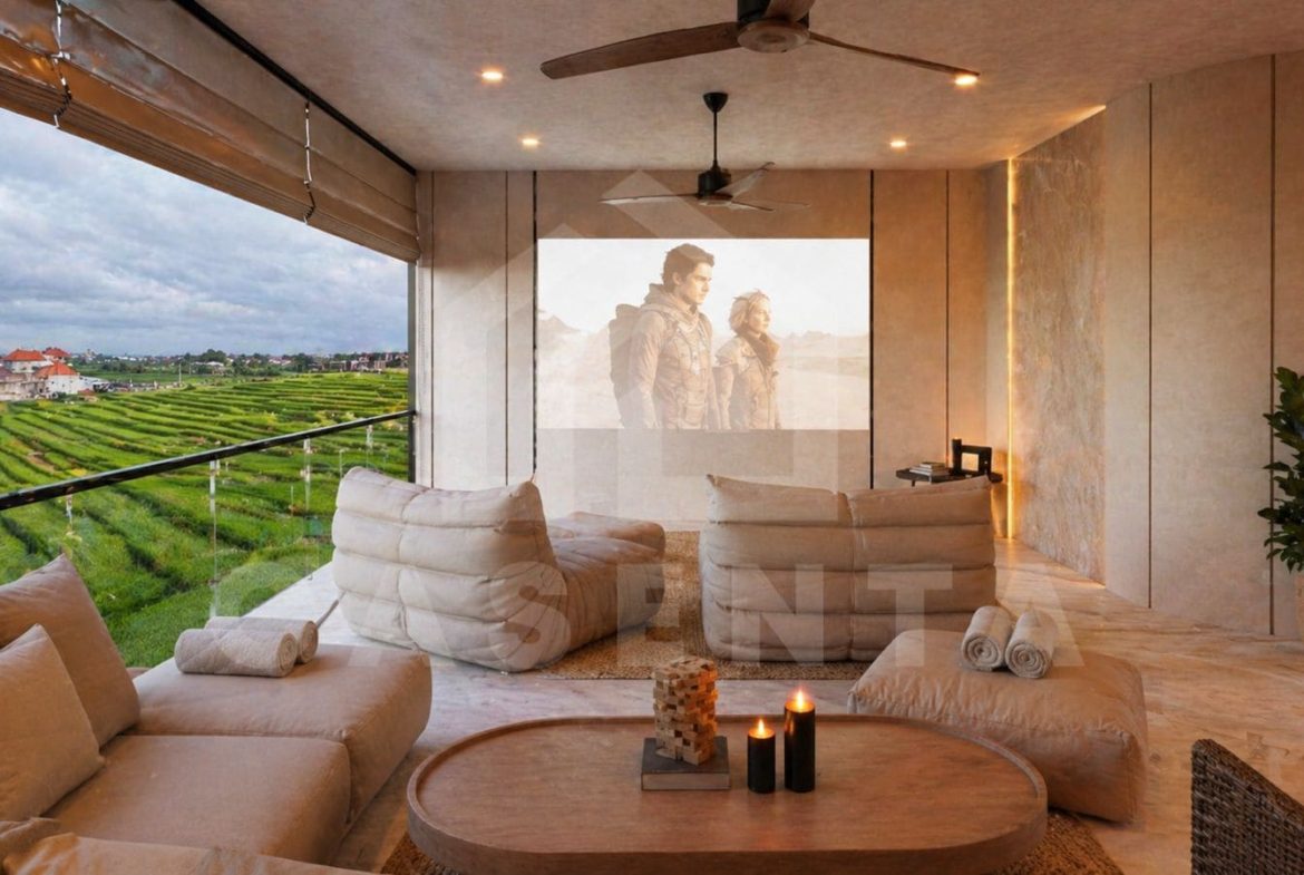 Cozy rooftop cinema lounge with plush seating, soft lighting, and tropical palm views.