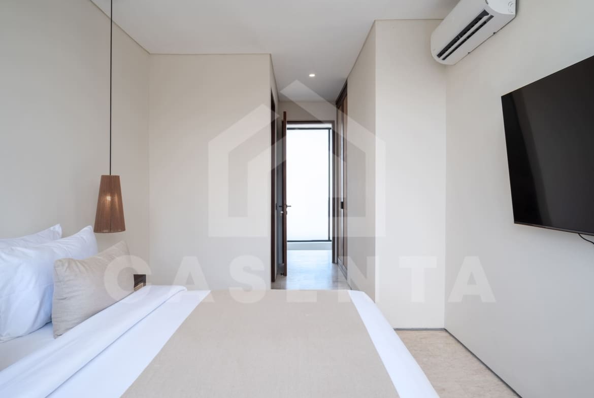 Modern ensuite bedroom in batu bolong villa with pendant lighting and neutral design