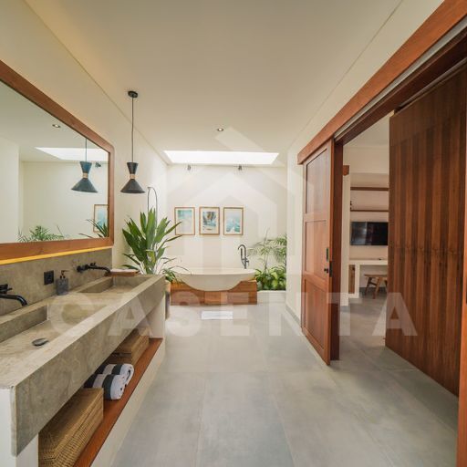 Modern ensuite bathroom in cemagi villa with double vanity and skylight