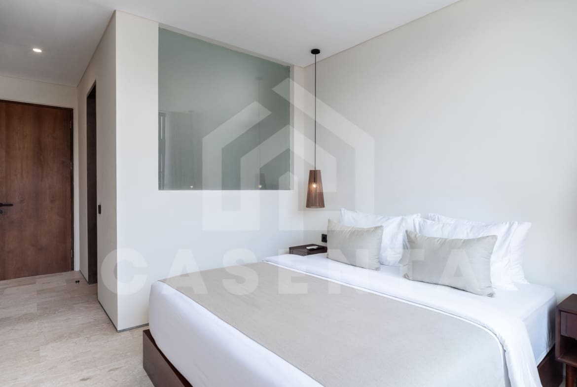 Second bedroom in contemporary batu bolong villa with built-in storage and AC