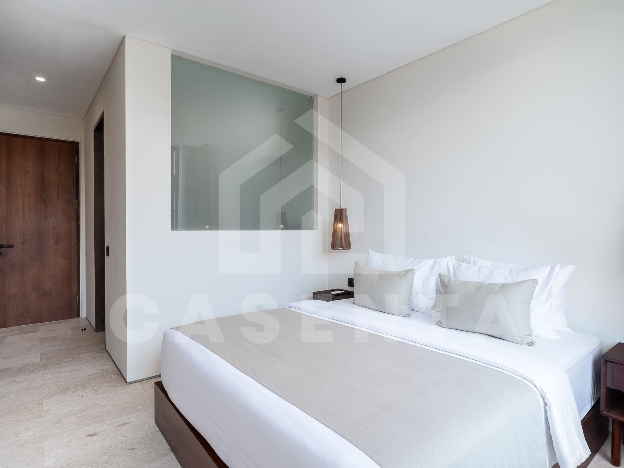 Second bedroom in contemporary batu bolong villa with built-in storage and AC