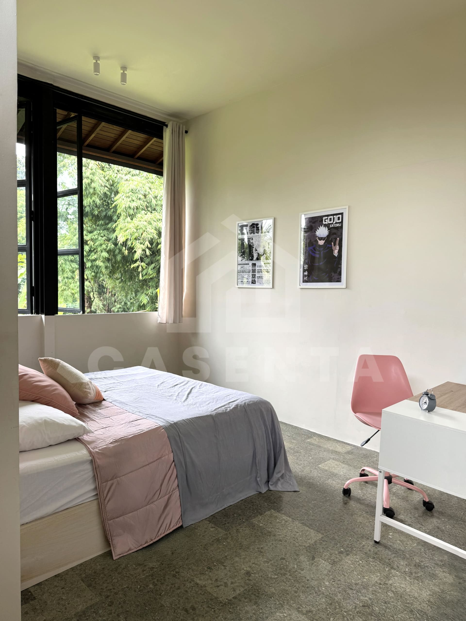 Secondary bedroom in Ubud villa with large window and natural light