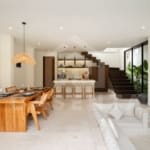 Open plan living and dining area in batu bolong villa with staircase feature