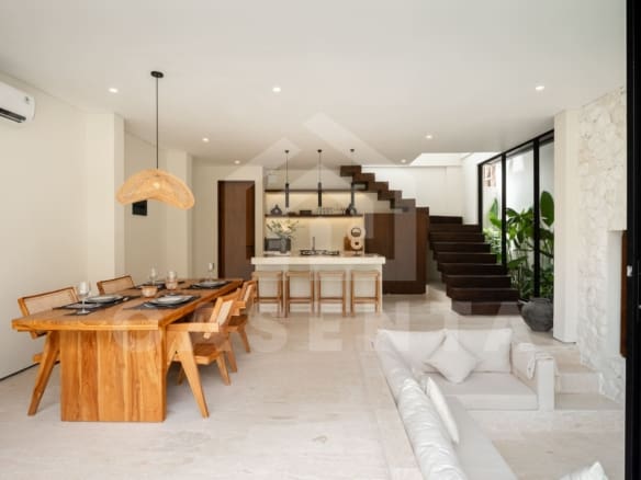 Open plan living and dining area in batu bolong villa with staircase feature