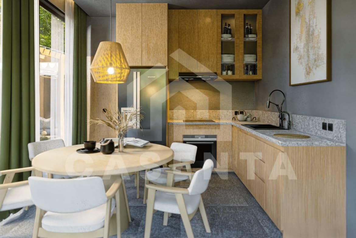 Open-plan kitchen and dining area in Ubud villa with wood cabinetry, modern appliances, and natural textures