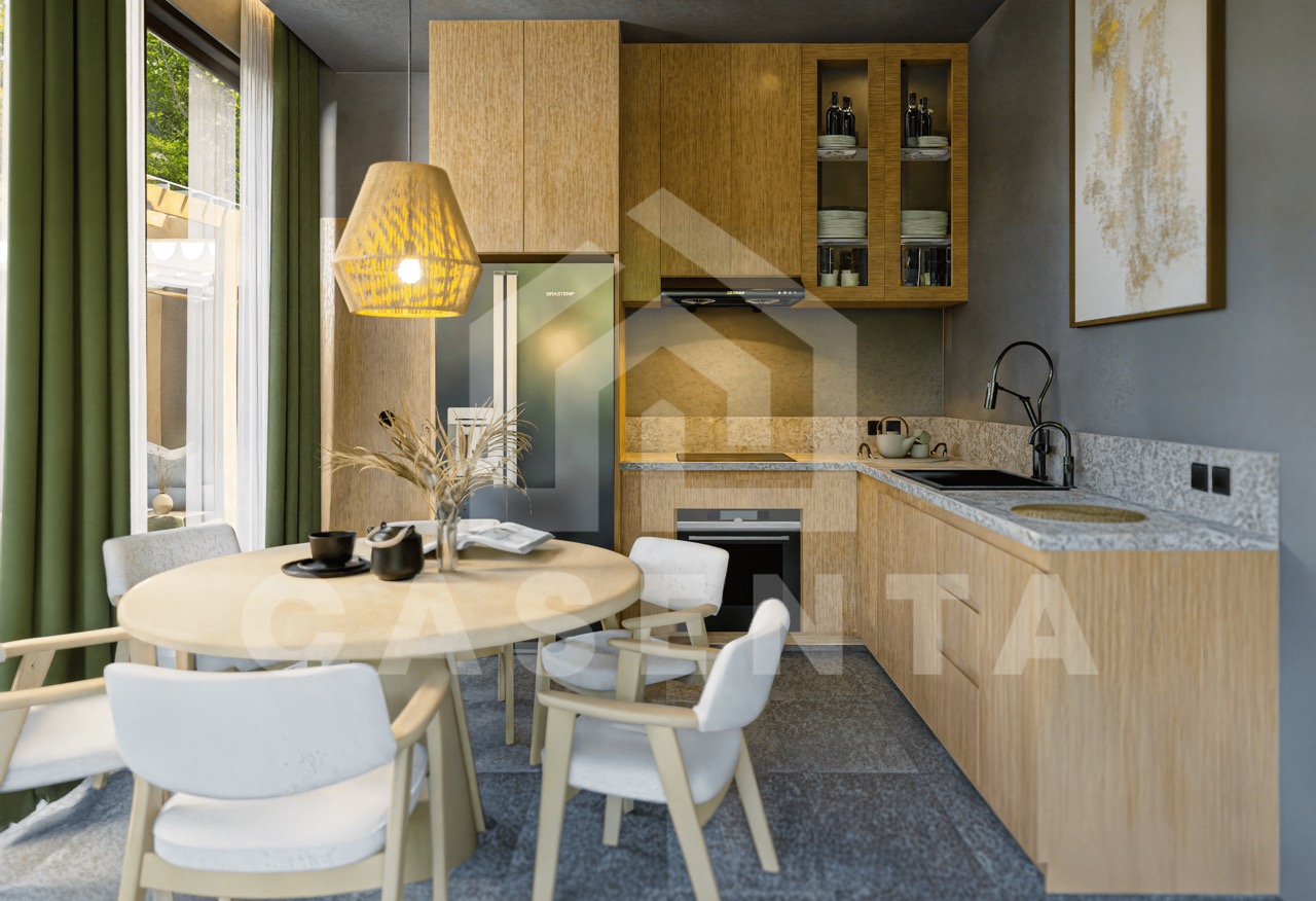 Open-plan kitchen and dining area in Ubud villa with wood cabinetry, modern appliances, and natural textures