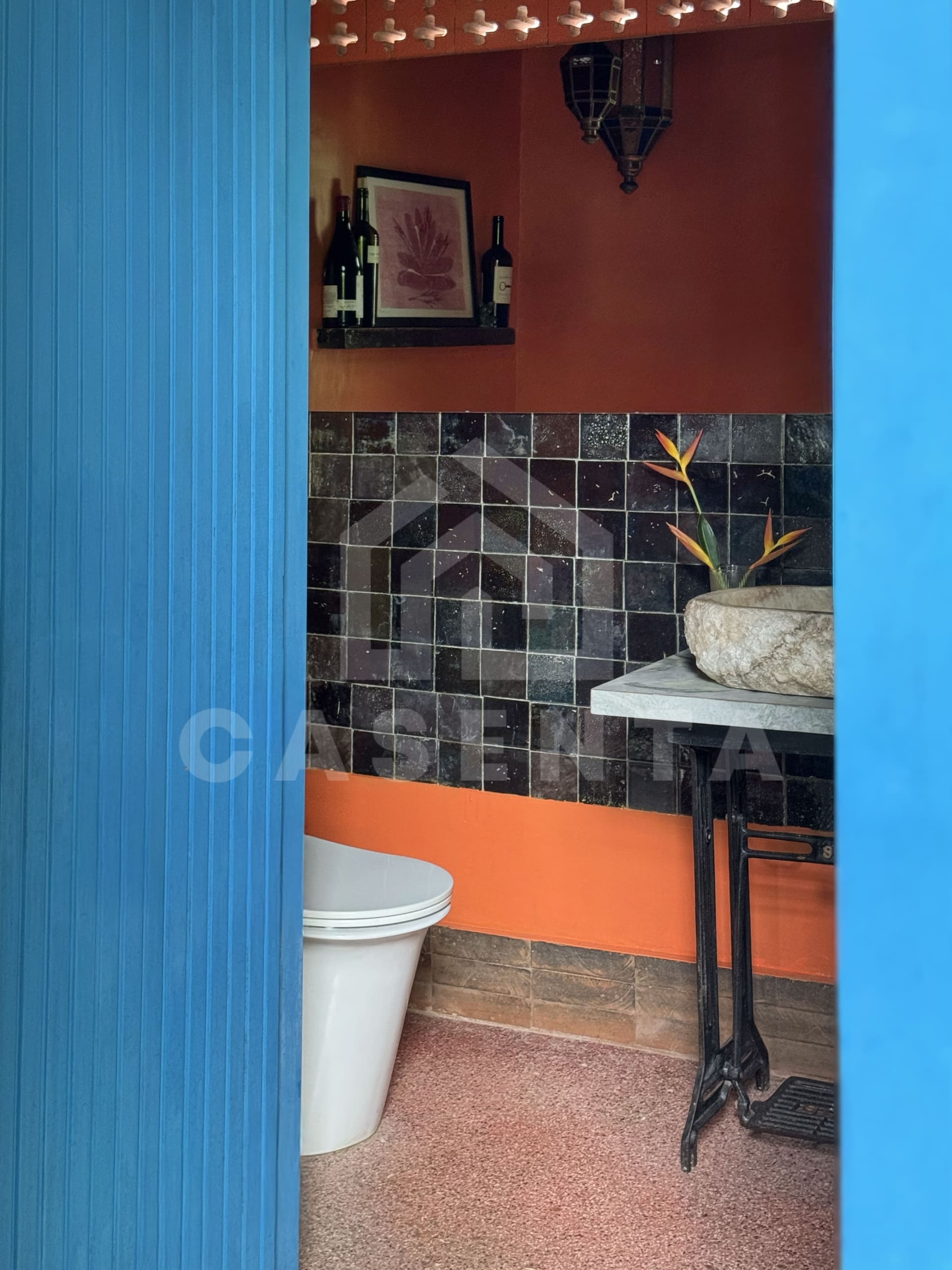 Guest toilet in Ubud villa with stone basin and feature tile wall