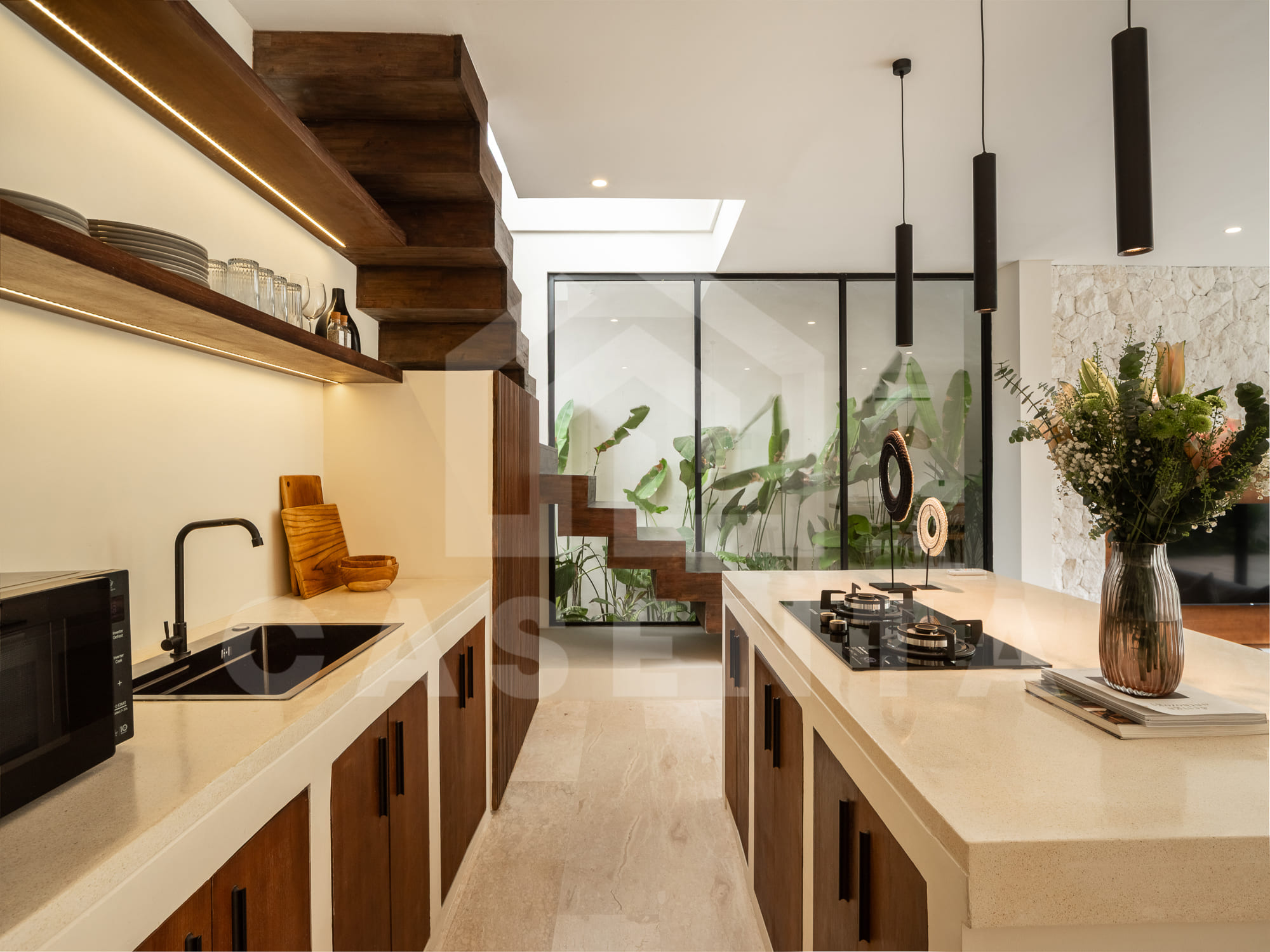 Modern kitchen in batu bolong villa with stone countertops and appliances
