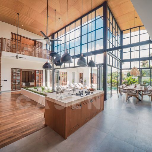 Open-plan living and kitchen in cemagi villa with high ceilings