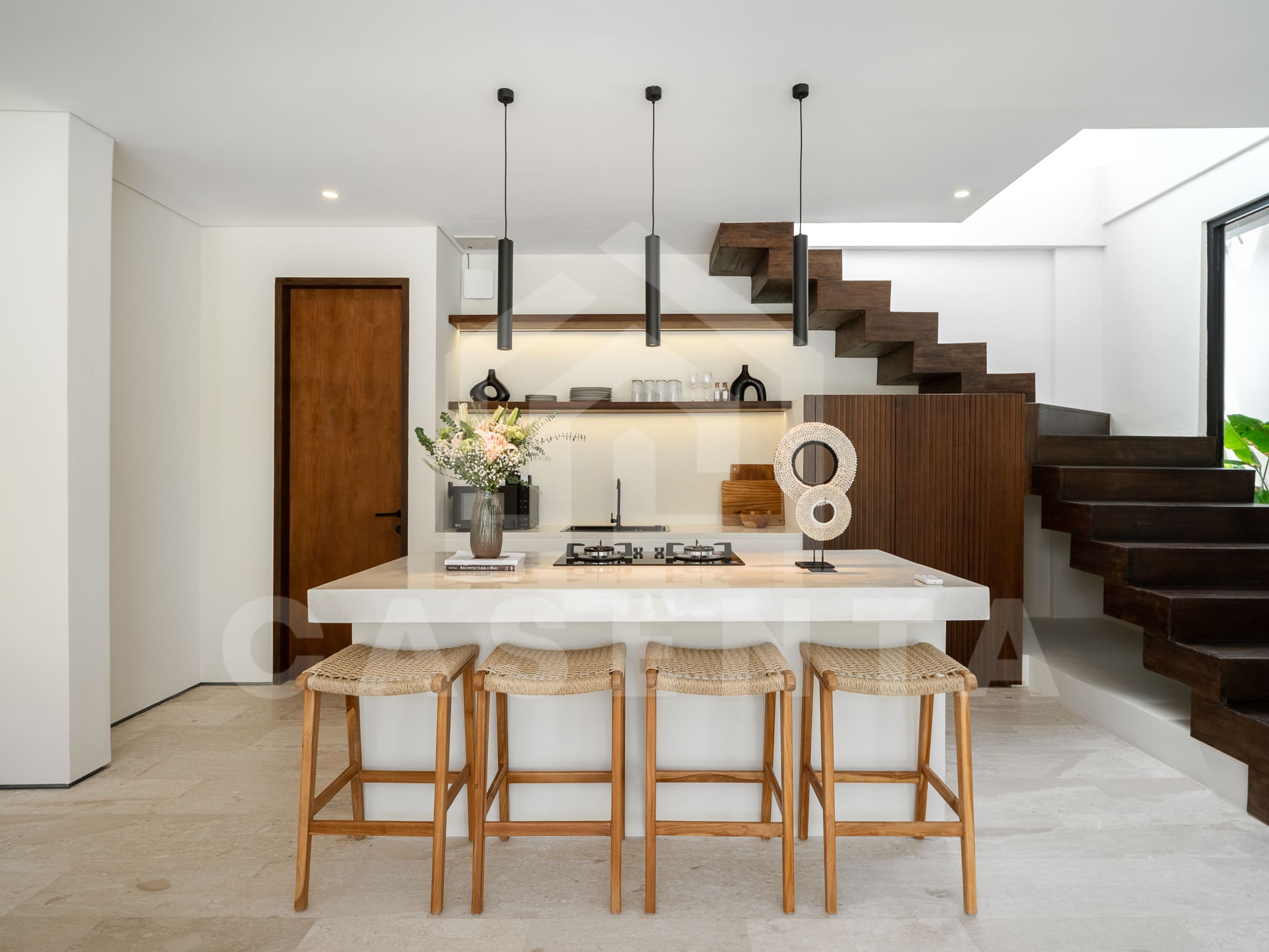 Kitchen island with bar stools in contemporary batu bolong villa