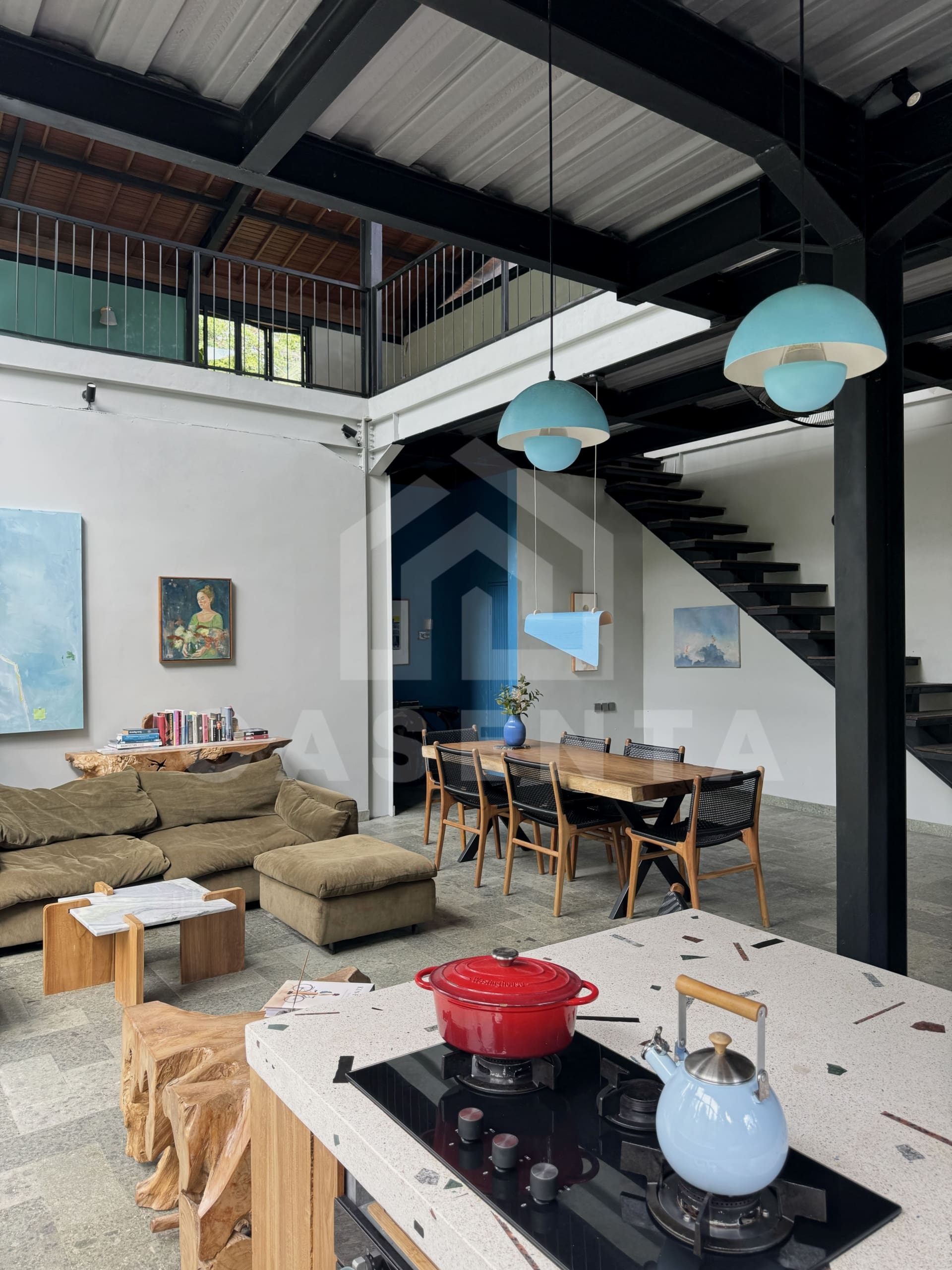 Open-plan kitchen and dining area in Ubud villa with high ceiling