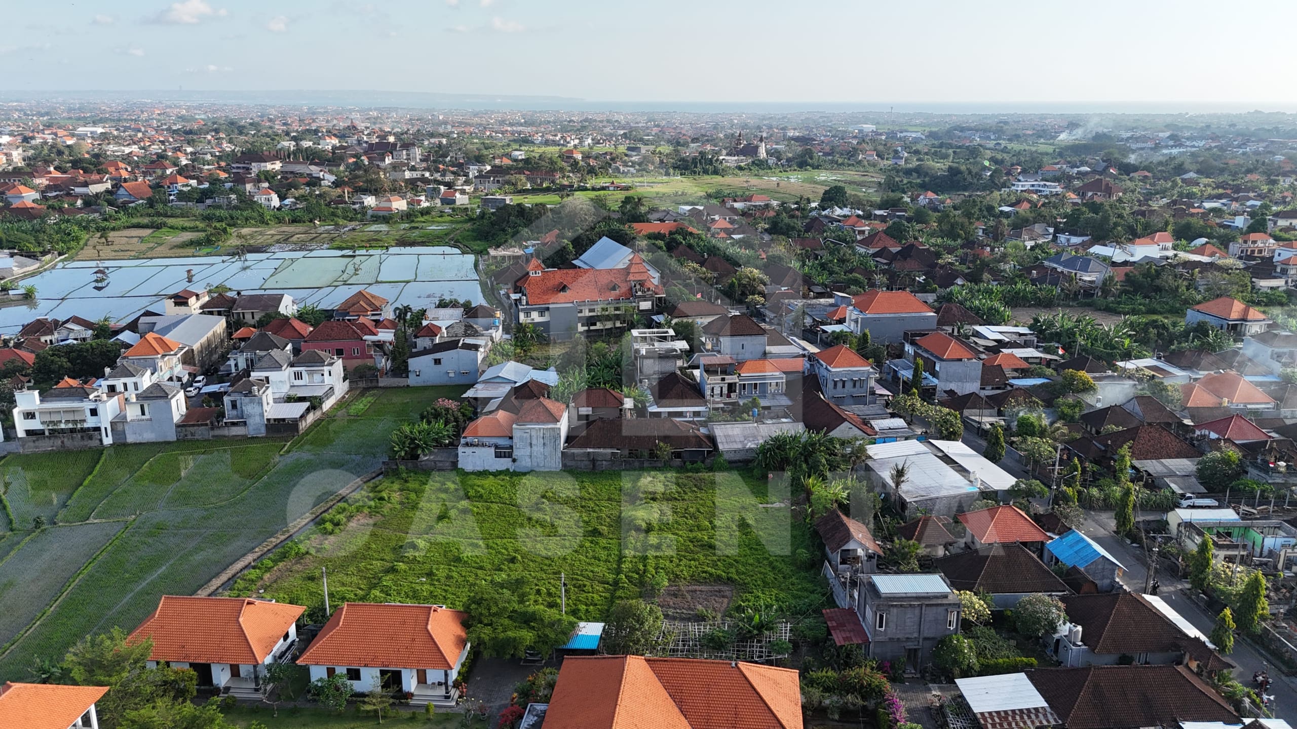 Buduk land bordered by rice fields and villas
