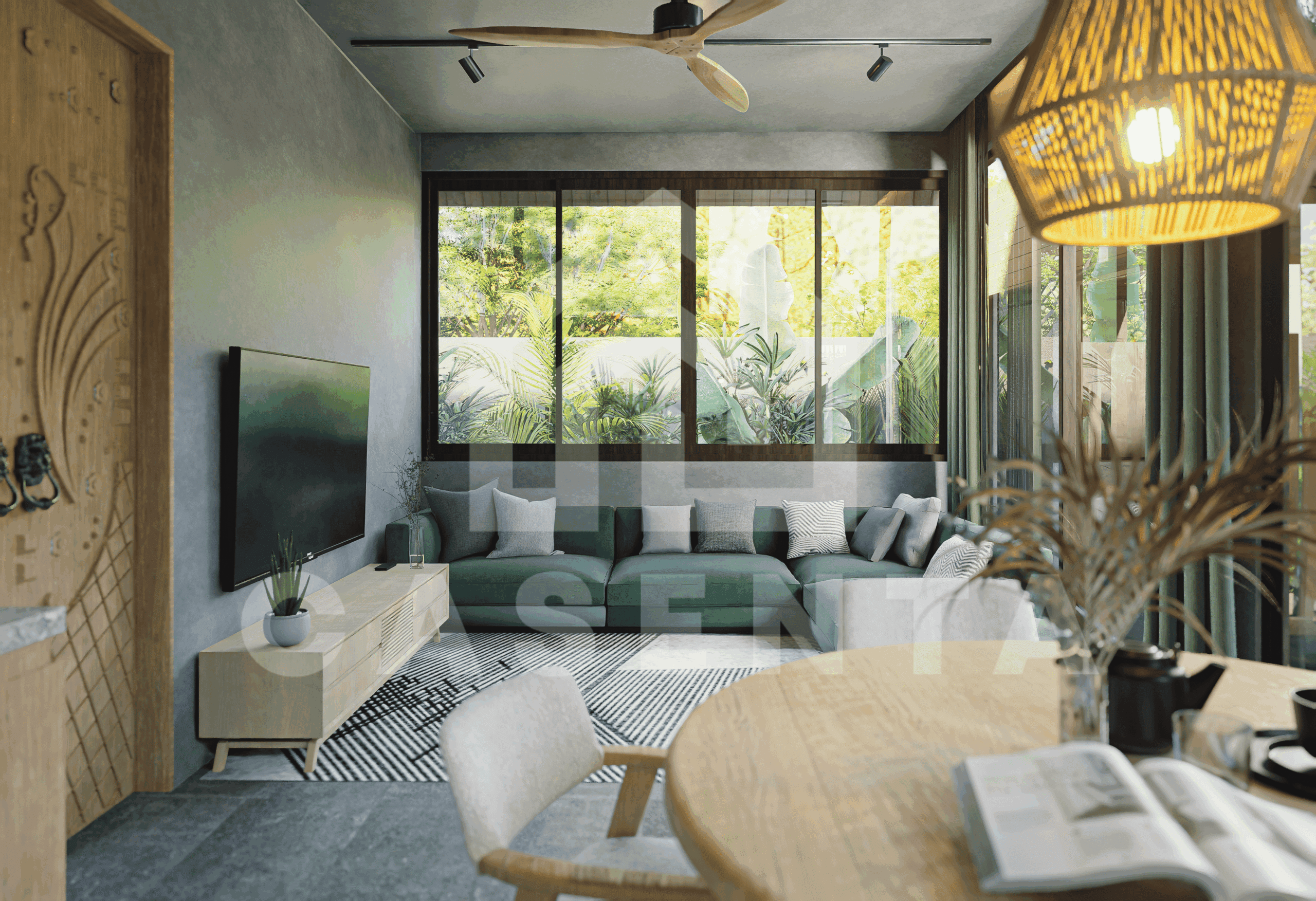 Living area in Ubud leasehold villa with large windows, green sofa, and indoor-outdoor garden views