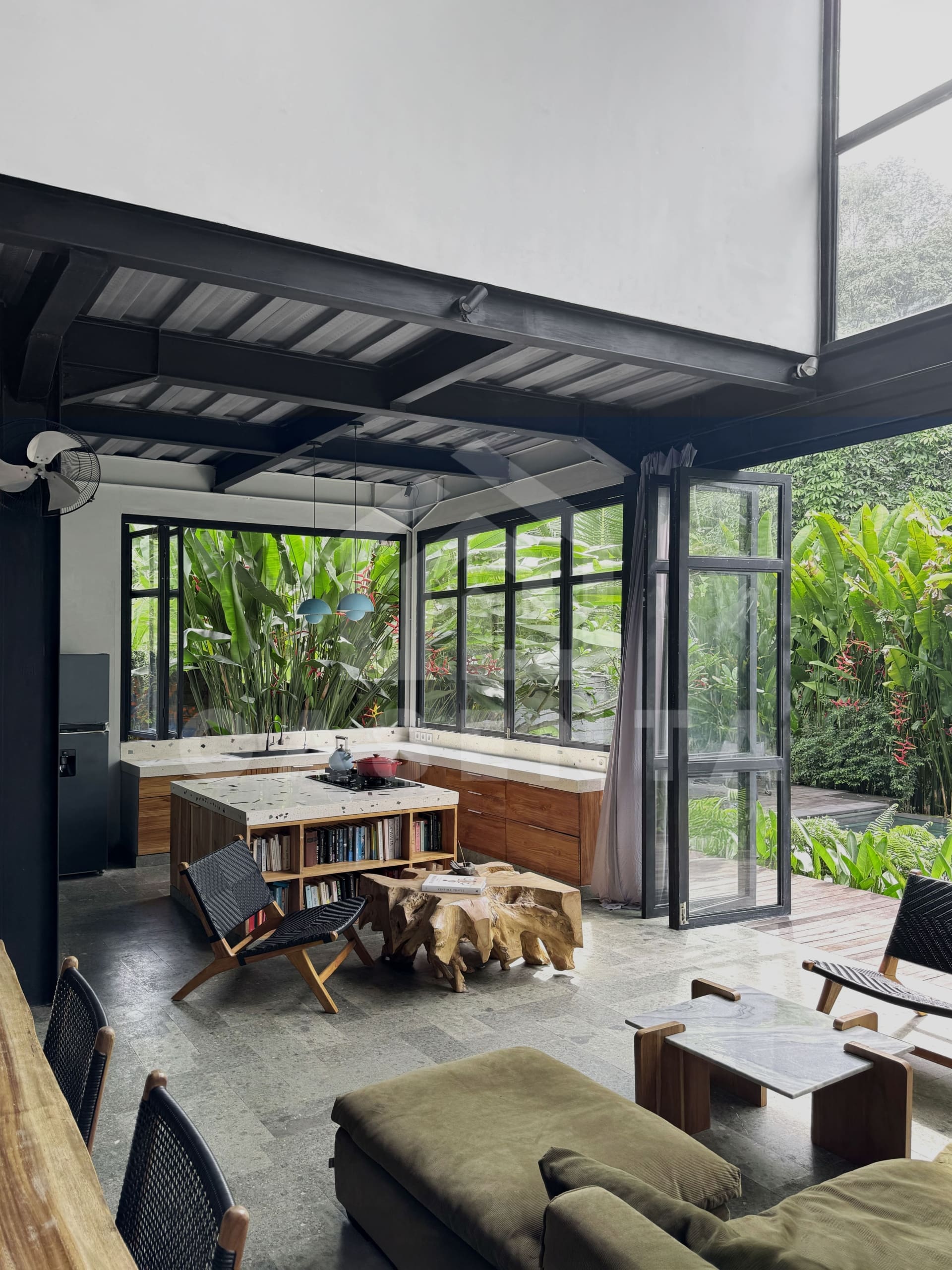 Modern kitchen with island in Ubud villa surrounded by greenery