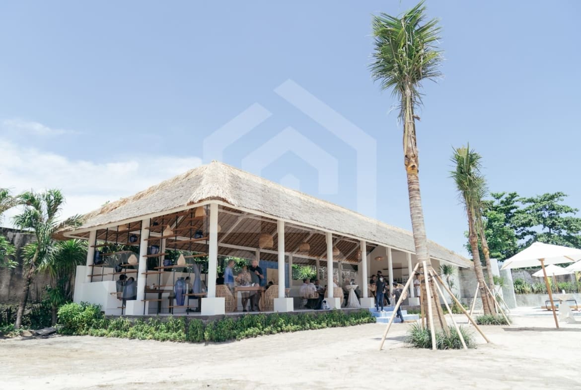 Open-air restaurant and lounge area at Jimbaran villa with thatched roof pavilion