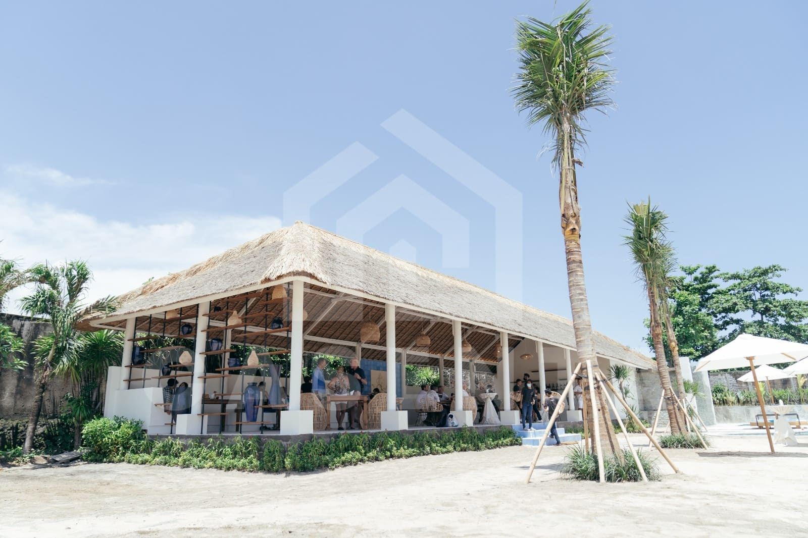 Open-air restaurant and lounge area at Jimbaran villa with thatched roof pavilion