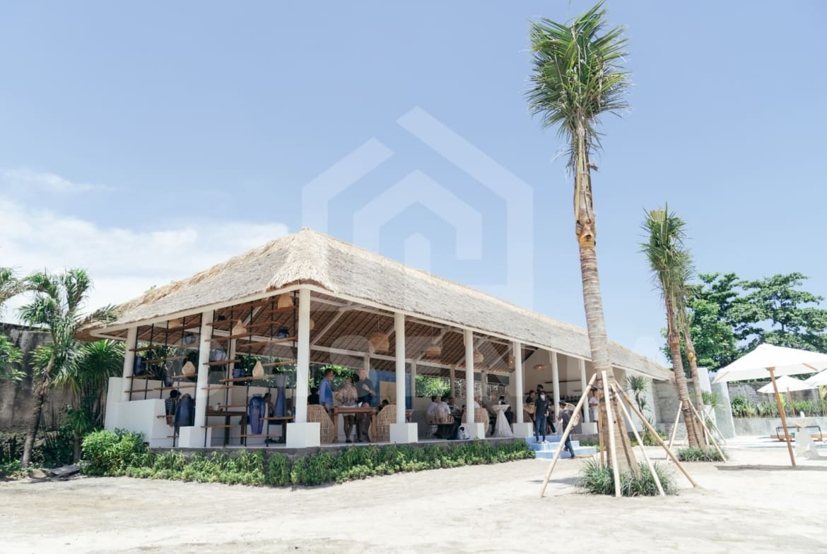 Open-air restaurant and lounge area at Jimbaran villa with thatched roof pavilion