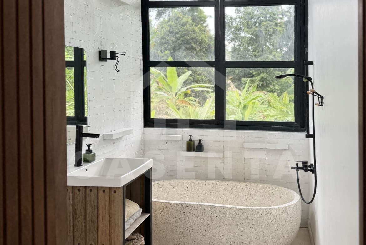 Freestanding bathtub in Ubud villa bathroom with large window