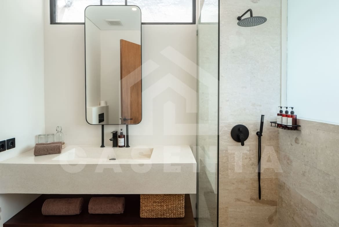 Modern bathroom with rain shower in batu bolong villa