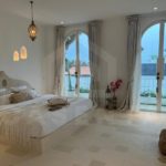 Bright bedroom in aesthetic seseh villa with balcony doors and Mediterranean interior design